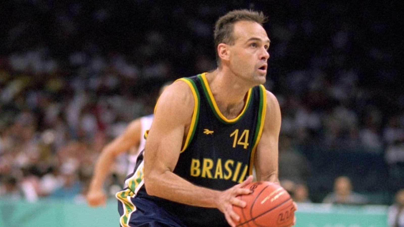 Basketball player in Brazil jersey  dribbling the ball during a game on the court