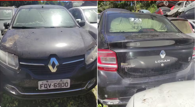 Image sorocabanices Front view of a dusty dark Renault car with license plate FQV in a cluttered lot