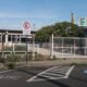 Entrance to Instituto Federal São Paulo campus Sorocaba with a gated fence and a handicap parking space marked on the pavement fringing a blue and white symbol wheelchair