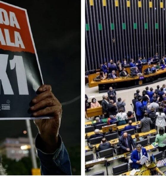 Close up of a protester holding a sign that reads FIM DA ESCALA X during a night demonstration