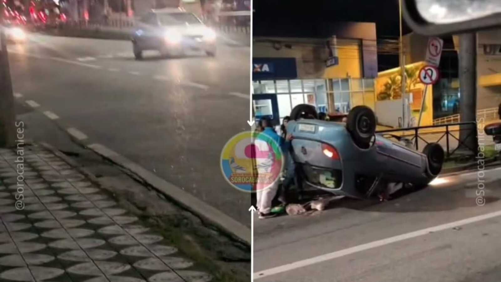 Nighttime scene of a blue car upside down on a city street while people assist at the roadside