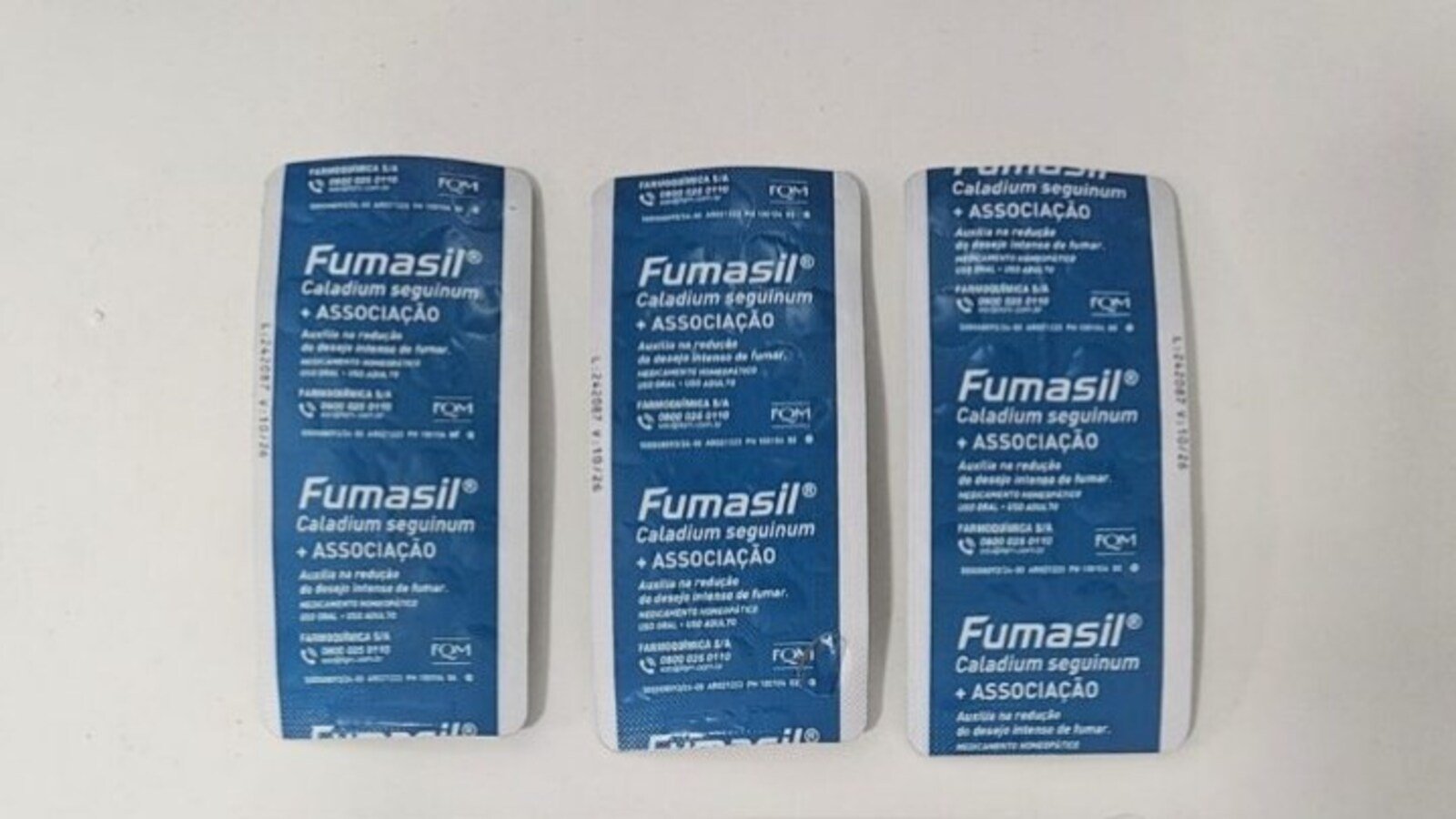 Three blue Fumasil medicine blister packs lined up on a white surface