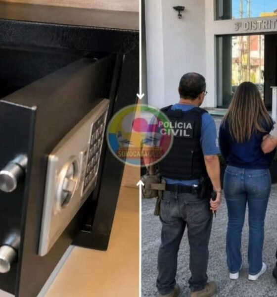Open safe displaying cash and gold watches outside people stand near a São Paulo Civil Police station entrance