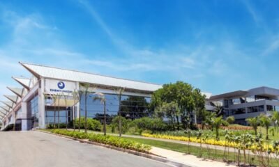 Modern glass front corporate building with ChemyUnion sign surrounded by palm trees on a sunny day