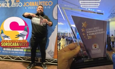 Man posing with a glass trophy in front of a blue event banner that reads Concurso Jornalístico e Publicitário with a large colorful logo and pigeons left panel of a split photo