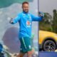Brazilian footballer in blue training kit giving thumbs up on a sports stagefield smiling at the camera