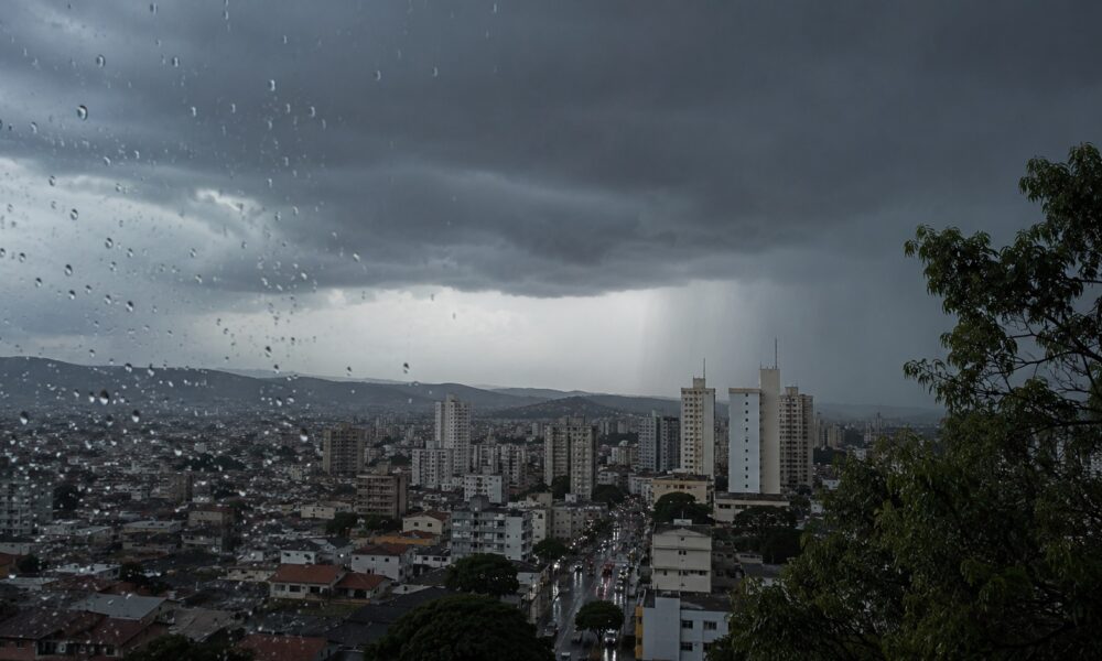 City skyline under dark storm clouds raindrops on a window fill the foreground