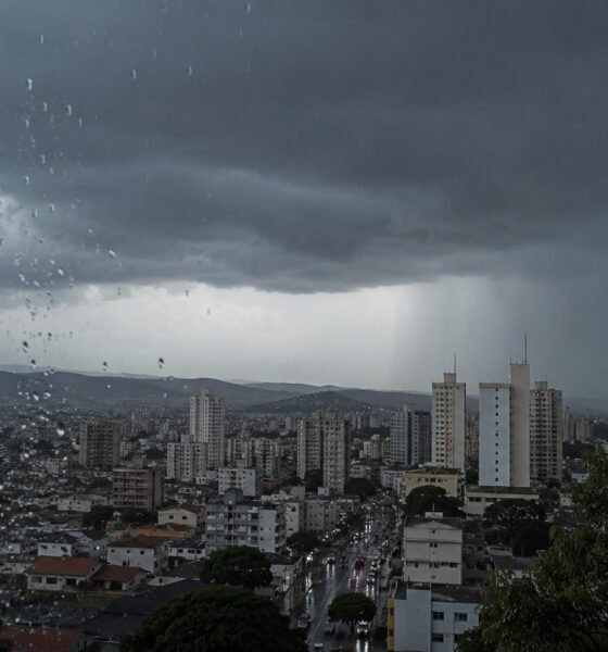 City skyline under dark storm clouds raindrops on a window fill the foreground