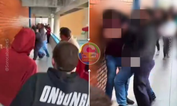 Crowd of students in a school hallway some facing a brick wall right side shows blurred faces to protect privacy