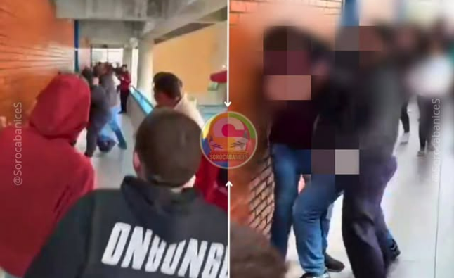 Crowd of students in a school hallway some facing a brick wall right side shows blurred faces to protect privacy