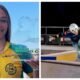Portrait of a smiling female athlete in a yellow green jersey holding a glass trophy that reads Roller World Cup against a blue sky background with abstract lines on the trophy surface indicating an award ceremony stay in photo