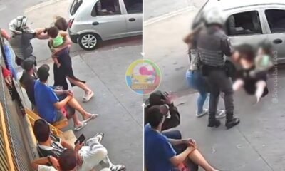 Split screen street scene left side shows a confrontation with a man restraining another person while bystanders sit along the curb right side shows a police officer escorting someone toward a parked car with a blurred group nearby