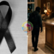 Left black awareness ribbon on a light wooden surface right a man in a hoodie approaches a hotel reception desk blurred figure nearby circular logo in center