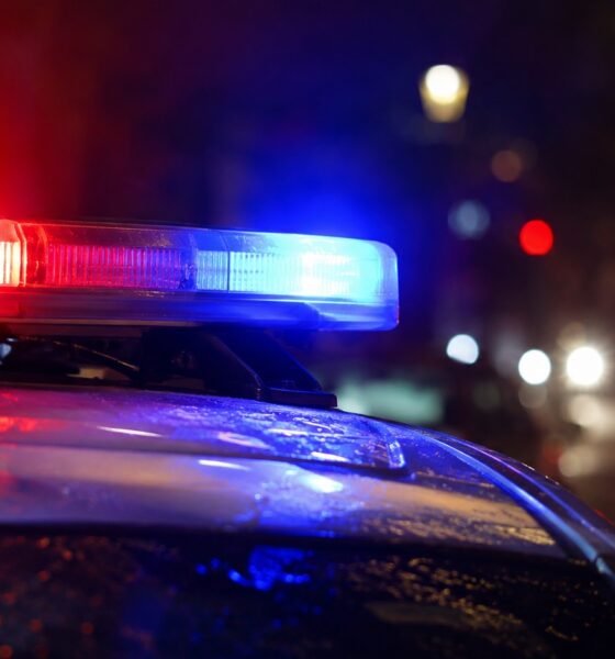 Police car with red and blue emergency lights flashing at night