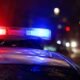 Police car with red and blue emergency lights flashing at night